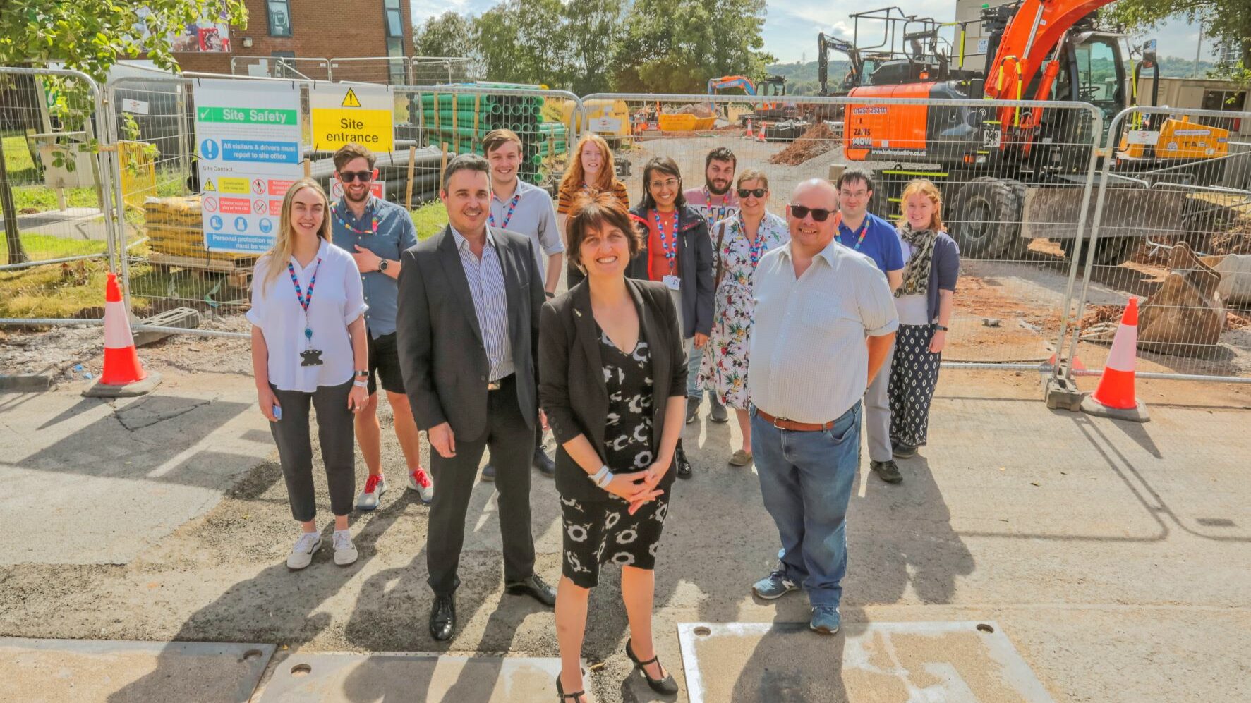 A group of people stood in front of a construction site.