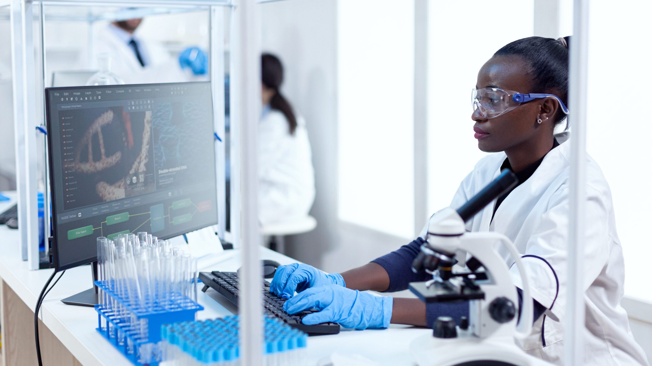 a woman at a computer in a medical lab doing research