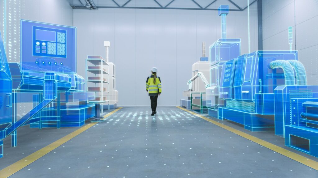 A woman in hard hat and high vis clothing on a digital factory floor