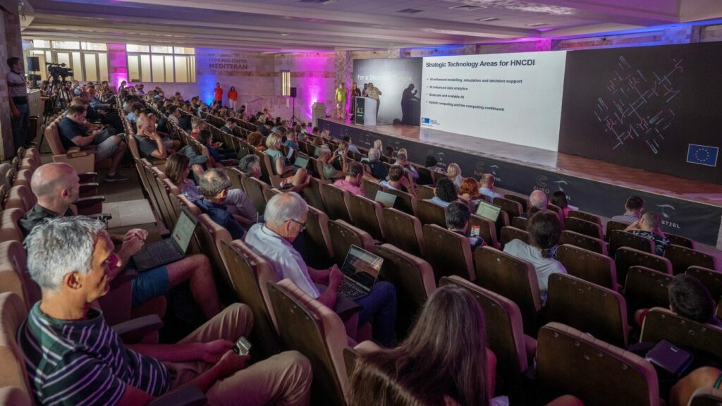 A lecture theatre full of people at a conference.