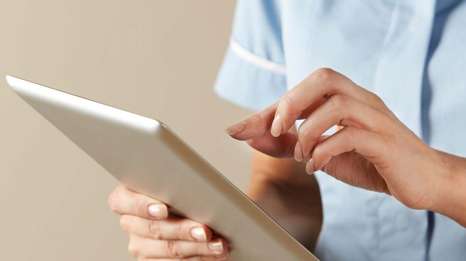 A nurse using a digital tablet.