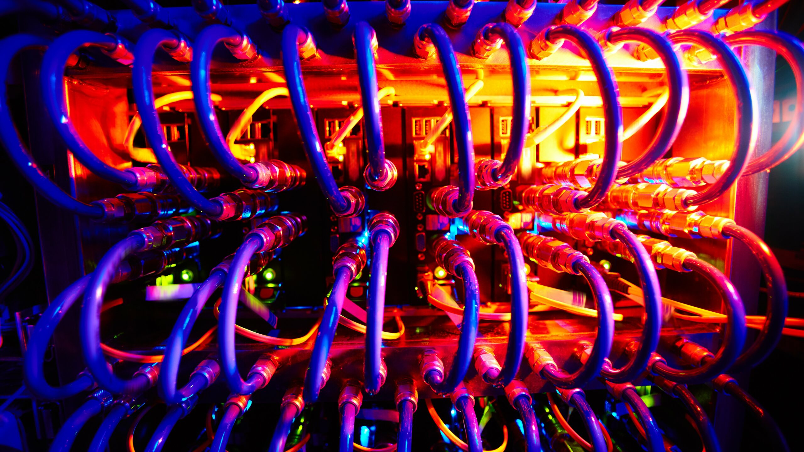 Supercomputer with row of cables in neon light