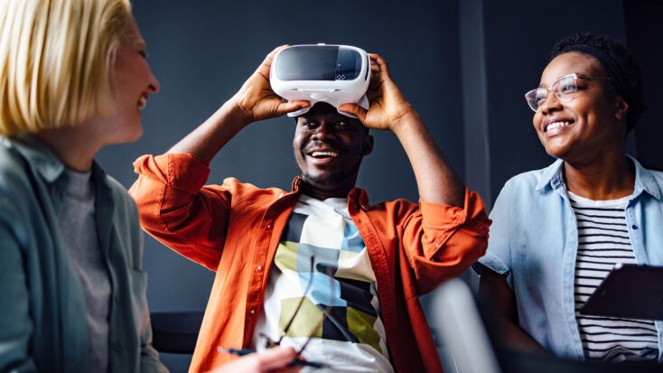 A group of adults smiling while using VR headset.